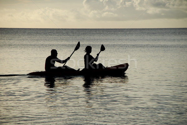 Kayakers silhouetted on the ocean Stock photo © sarahdoow