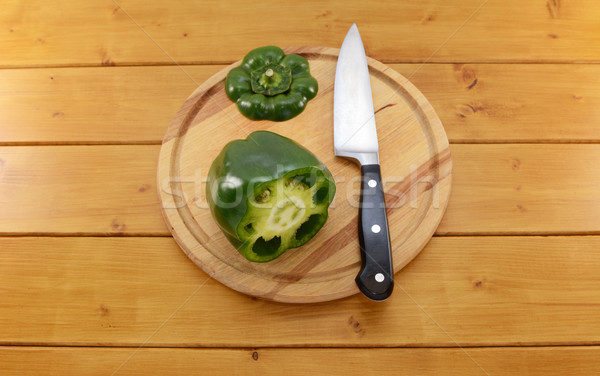 Green pepper sliced open with a knife on a chopping board Stock photo © sarahdoow