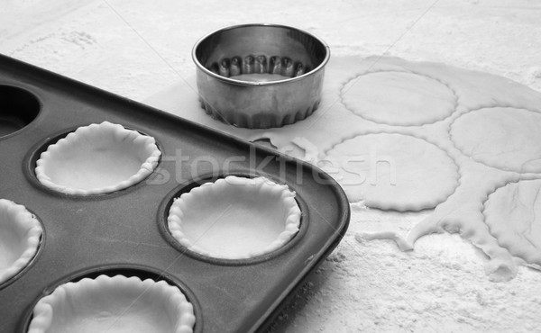 Pastry circles cut and lining a metal bun tin Stock photo © sarahdoow