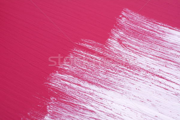 Brush strokes of white paint across a pink surface Stock photo © sarahdoow