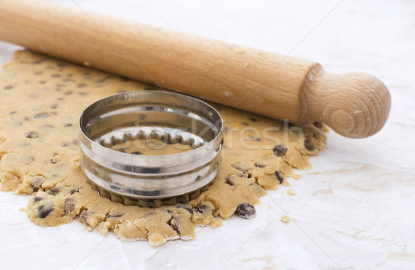 Cookie cutter and rolling pin on cookie dough Stock photo © sarahdoow