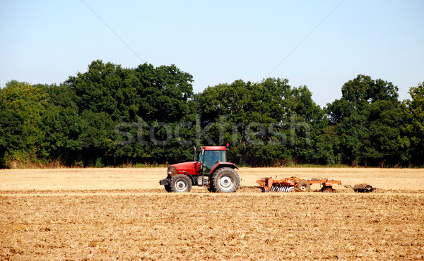 Tractor and harrow cultivating the soil Stock photo © sarahdoow