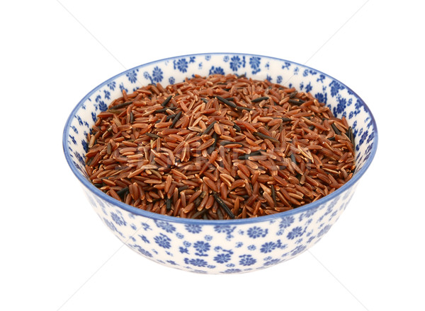 Camargue red rice in a blue and white china bowl Stock photo © sarahdoow