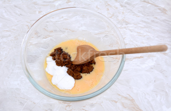 Stirring caster and muscovado sugar into beaten egg Stock photo © sarahdoow