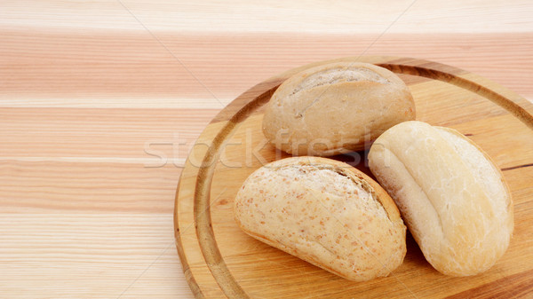 Three crusty petit pain on a bread board Stock photo © sarahdoow