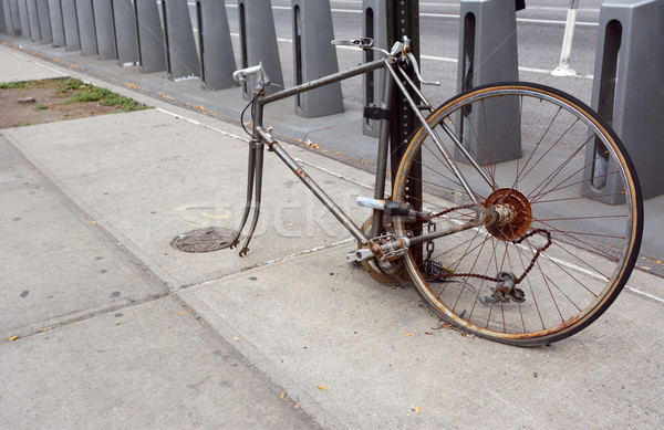 Broken, rusty bicycle locked to a metal pole Stock photo © sarahdoow