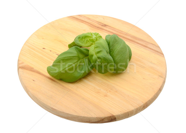 Sprig of fresh basil leaves on a chopping board Stock photo © sarahdoow
