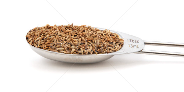 Cumin seeds measured in a metal tablespoon Stock photo © sarahdoow