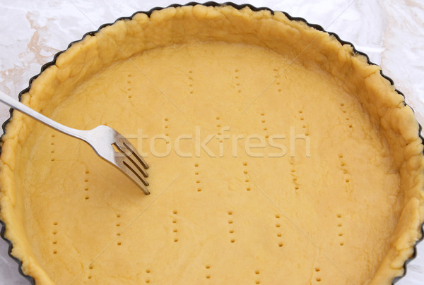 Stock photo: Fork making holes in a raw pastry case