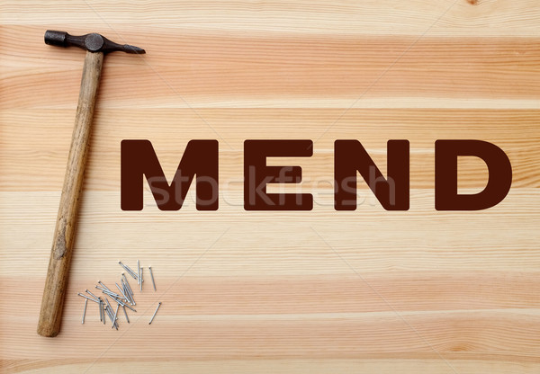 Stock photo: Hammer and panel pins - MEND written on wood