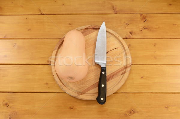 Stock photo: Butternut squash with a knife on a chopping board