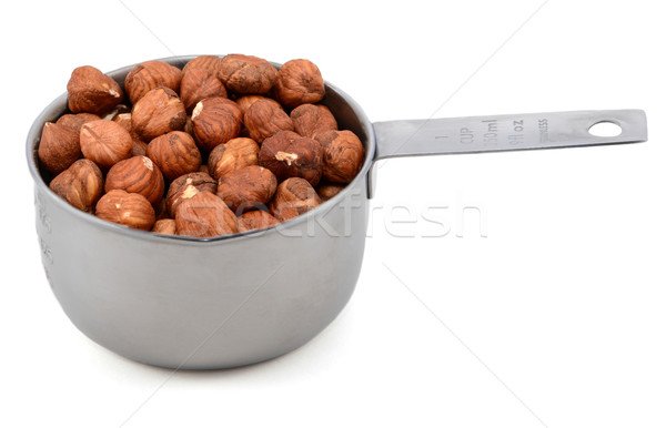 Whole hazelnuts in a metal cup measure Stock photo © sarahdoow