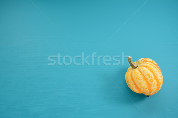Yellow Festival squash on a teal wooden background Stock photo © sarahdoow