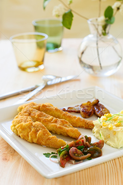 Breaded chicken with tomato salad and potato Stock photo © sarsmis