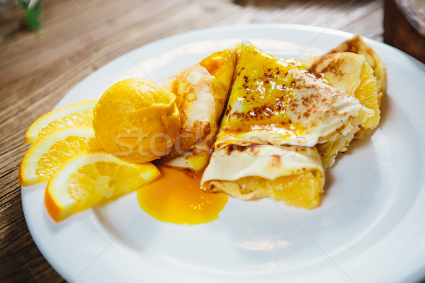 stuffed pancakes with orange syrup and ice-cream Stock photo © sarymsakov