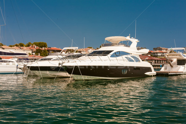 Row of luxury motorised yachts moored in a sheltered harbour Stock photo © sarymsakov