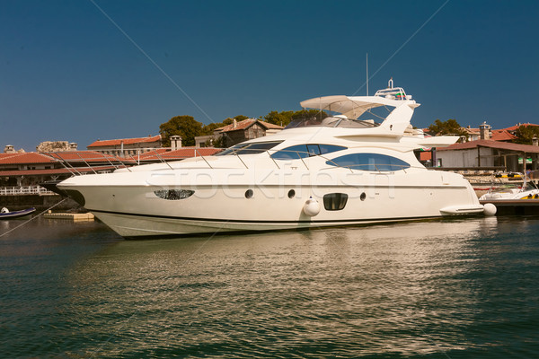 Row of luxury motorised yachts moored in a sheltered harbour Stock photo © sarymsakov
