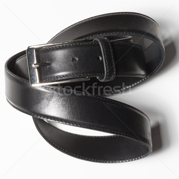 Black belt with a simple buckle on white background Stock photo © sarymsakov