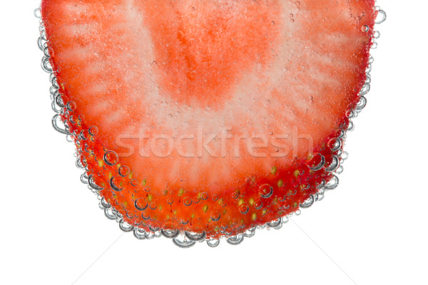 Morango fatia efervescente água bolha isolado Foto stock © scheriton