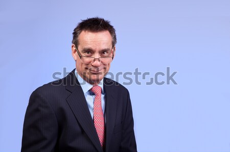 Smiling Business Man in Suit Looking Over Glasses Stock photo © scheriton