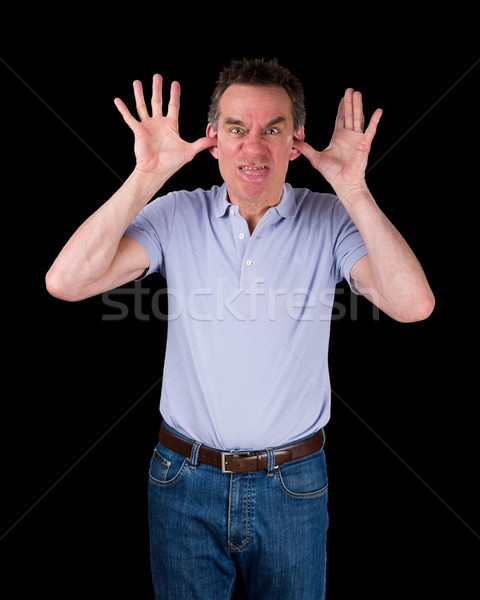 Angry Man Poking Out Tongue with Hands in Ears Stock photo © scheriton