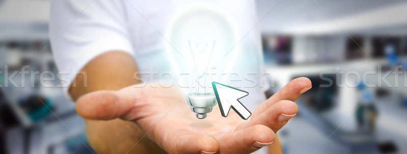 Businessman holding lightbulb Stock photo © sdecoret