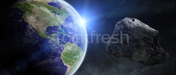 Asteroids threat over planet earth Stock photo © sdecoret