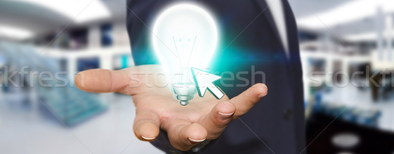 Businessman holding lightbulb Stock photo © sdecoret
