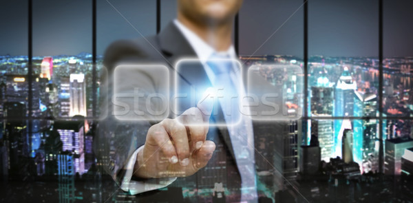 Businessman in his office using tactile interface Stock photo © sdecoret