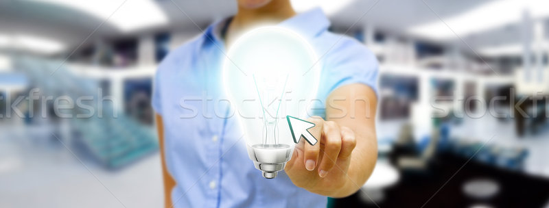 Businesswoman holding lightbulb Stock photo © sdecoret