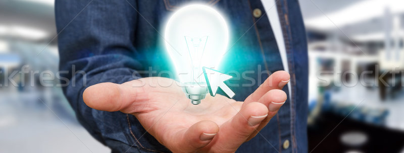 Businessman holding lightbulb Stock photo © sdecoret