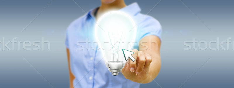 Businesswoman holding lightbulb Stock photo © sdecoret