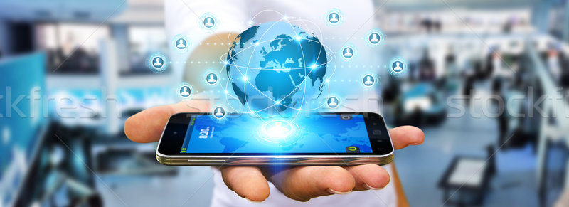 üzletember közösségi háló modern mobiltelefon kéz alkalmazás Stock fotó © sdecoret