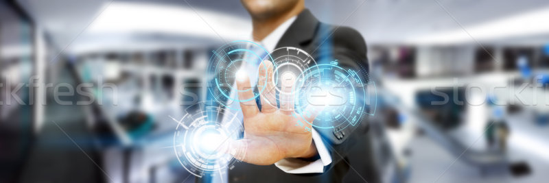 Businessman in his office using tactile interface Stock photo © sdecoret