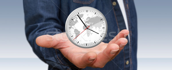 Businessman holding a clock in his hand Stock photo © sdecoret