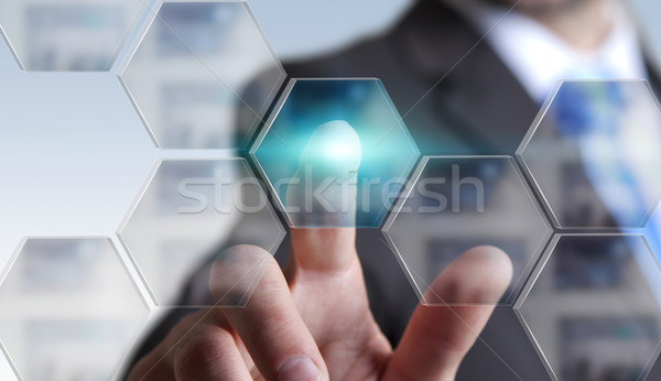 Businessman in his office using tactile interface Stock photo © sdecoret