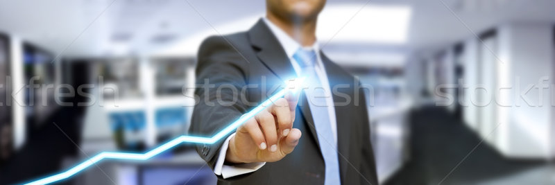 Businessman in his office using tactile interface Stock photo © sdecoret