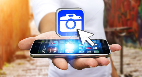 Young man using modern camera application Stock photo © sdecoret