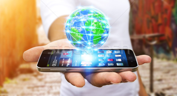 Businessman surfing on internet with modern mobile phone Stock photo © sdecoret