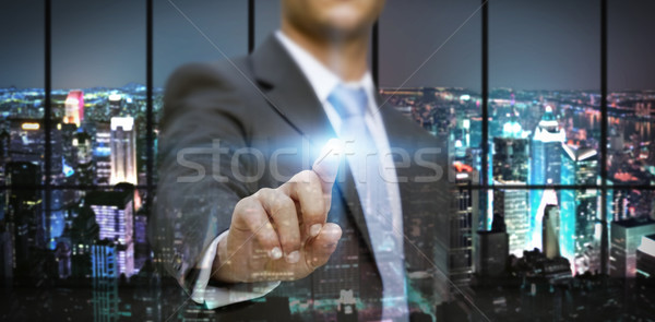 Businessman in his office using tactile interface Stock photo © sdecoret