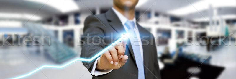 Businessman in his office using tactile interface Stock photo © sdecoret