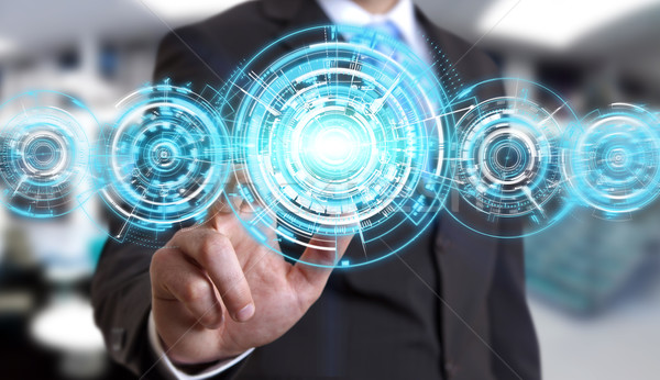 Businessman in his office using tactile interface Stock photo © sdecoret