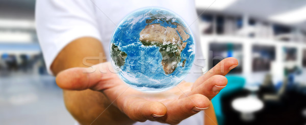 Man holding the planet earth in his hand Stock photo © sdecoret