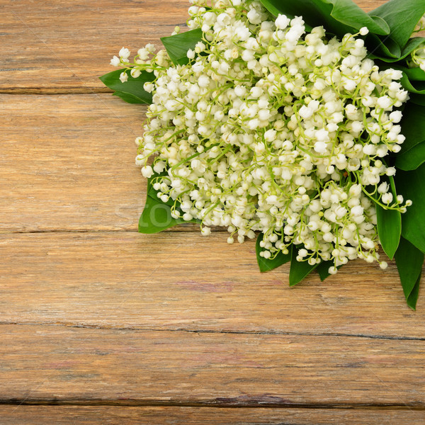 Stock photo: Bouquet lily of the valley on wooden table.