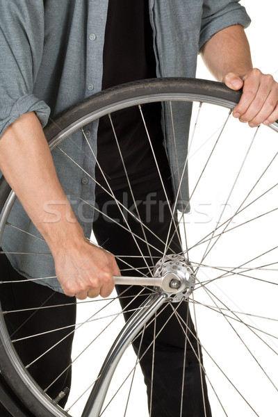 Stock photo: Man repairing front wheel on a bicycle
