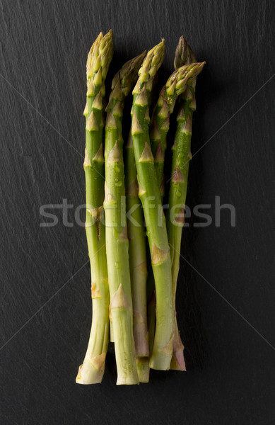 Bundle of fresh cut raw, uncooked green asparagus vegetable Stock photo © ShawnHempel