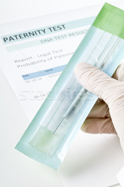 Paternity test result form with doctor holding buccal swab  Stock photo © ShawnHempel