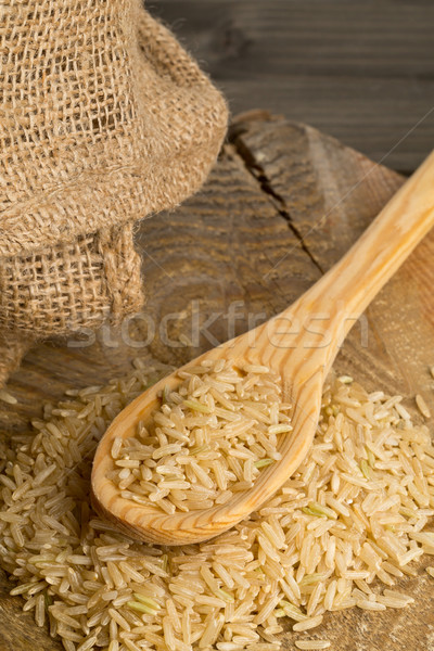 Natural brown uncooked rice on wooden spoon Stock photo © ShawnHempel