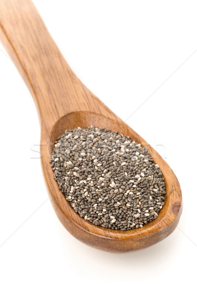 Whole dried black chai seeds in wooden spoon Stock photo © ShawnHempel