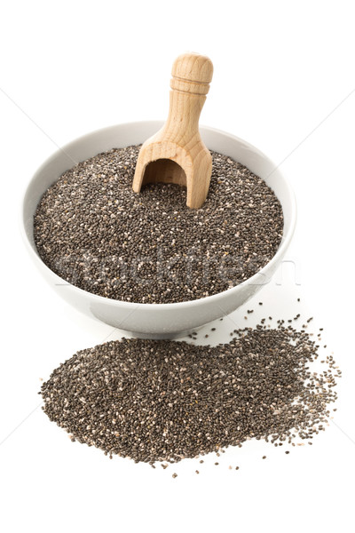 Raw, unprocessed, dried black chia seeds in white bowl with wood Stock photo © ShawnHempel